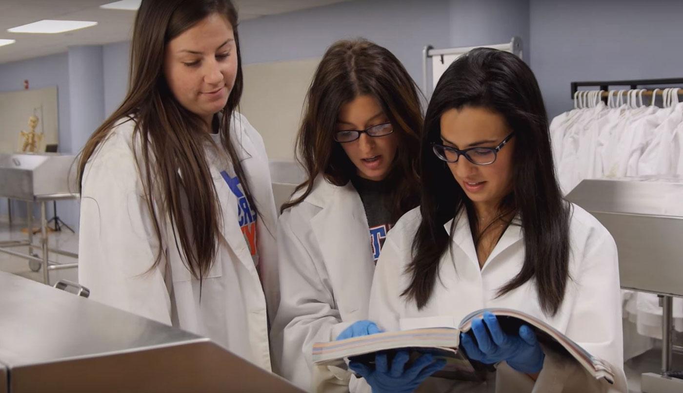 Students examine print materials in a lab